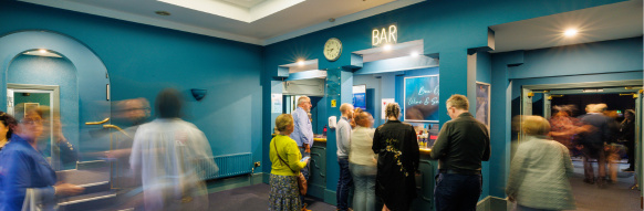 Group of People waiting in theatre foyer