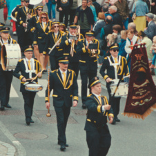 A marching band walking down the street