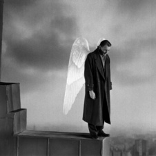 Man with white wings looking down