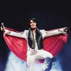 Elvis on stage with arms out
