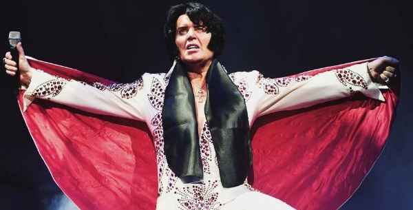 Elvis on stage with arms out
